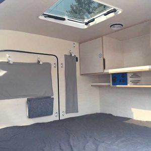 The window curtains offer privacy and extra insulation of the teardrop trailer
