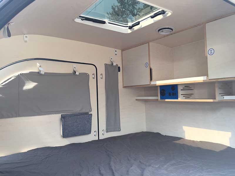 The window curtains offer privacy and extra insulation of the teardrop trailer