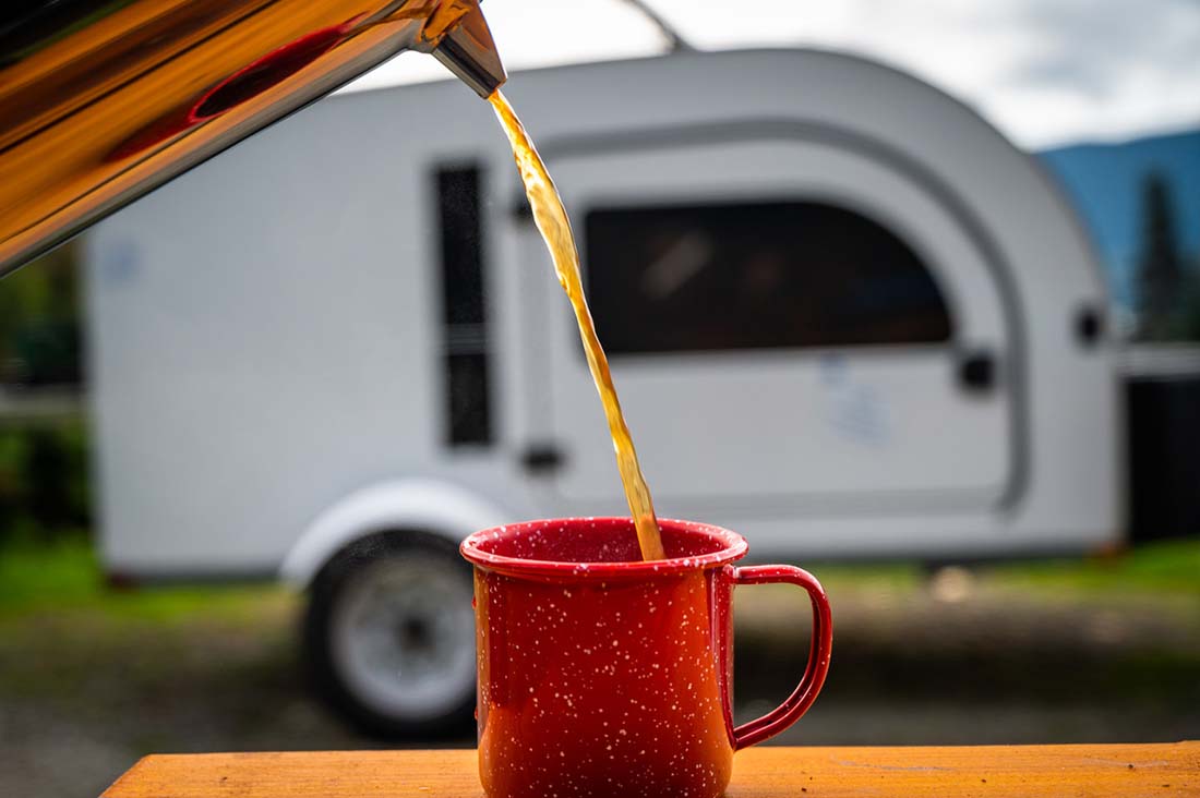 Coffee being poured in front of a DROPLET camper