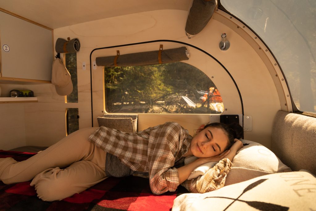 Woman sleeping in the DROPLET teardrop trailer