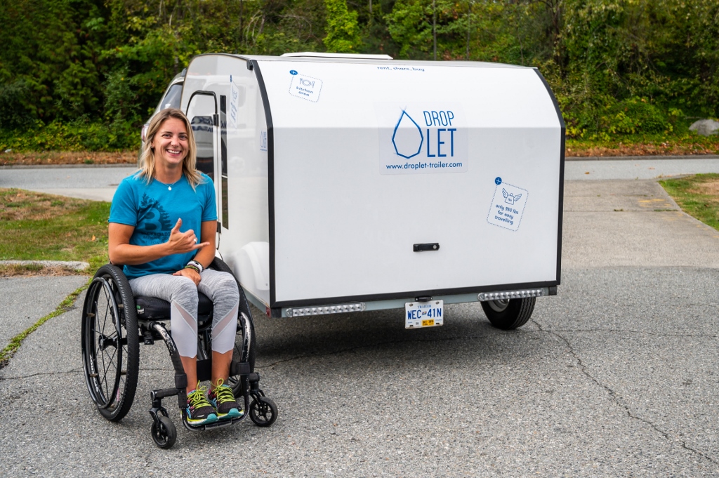 Woman on a wheelchair in front of a DROPLET 58 camper