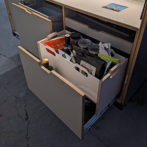 Groceries sit inside of our pantry tray.