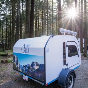 Artwork on the back of our trailer shows beautiful geometric mountains and a sky.