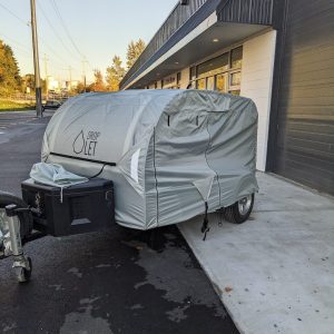 Our premium camper cover wraps itself fully around a teardrop trailer in our trailer shop in BC.