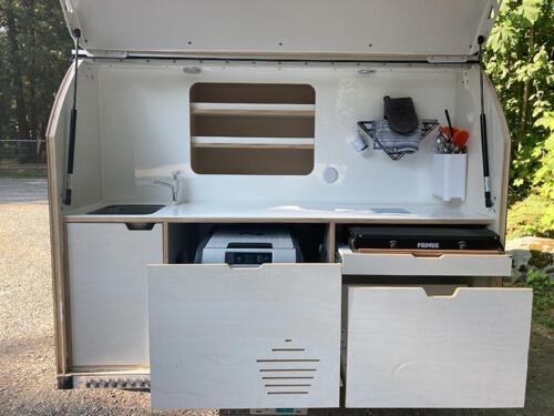Covered galley kitchen in ultra-light teardrop travel trailer